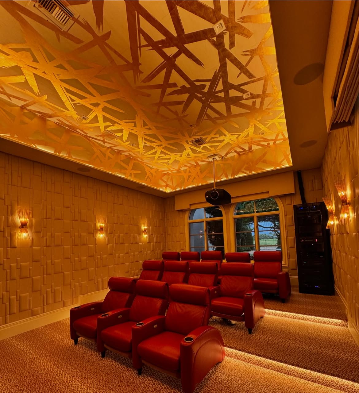 Indian Creek home theater with gold wallpaper installed on the ceiling