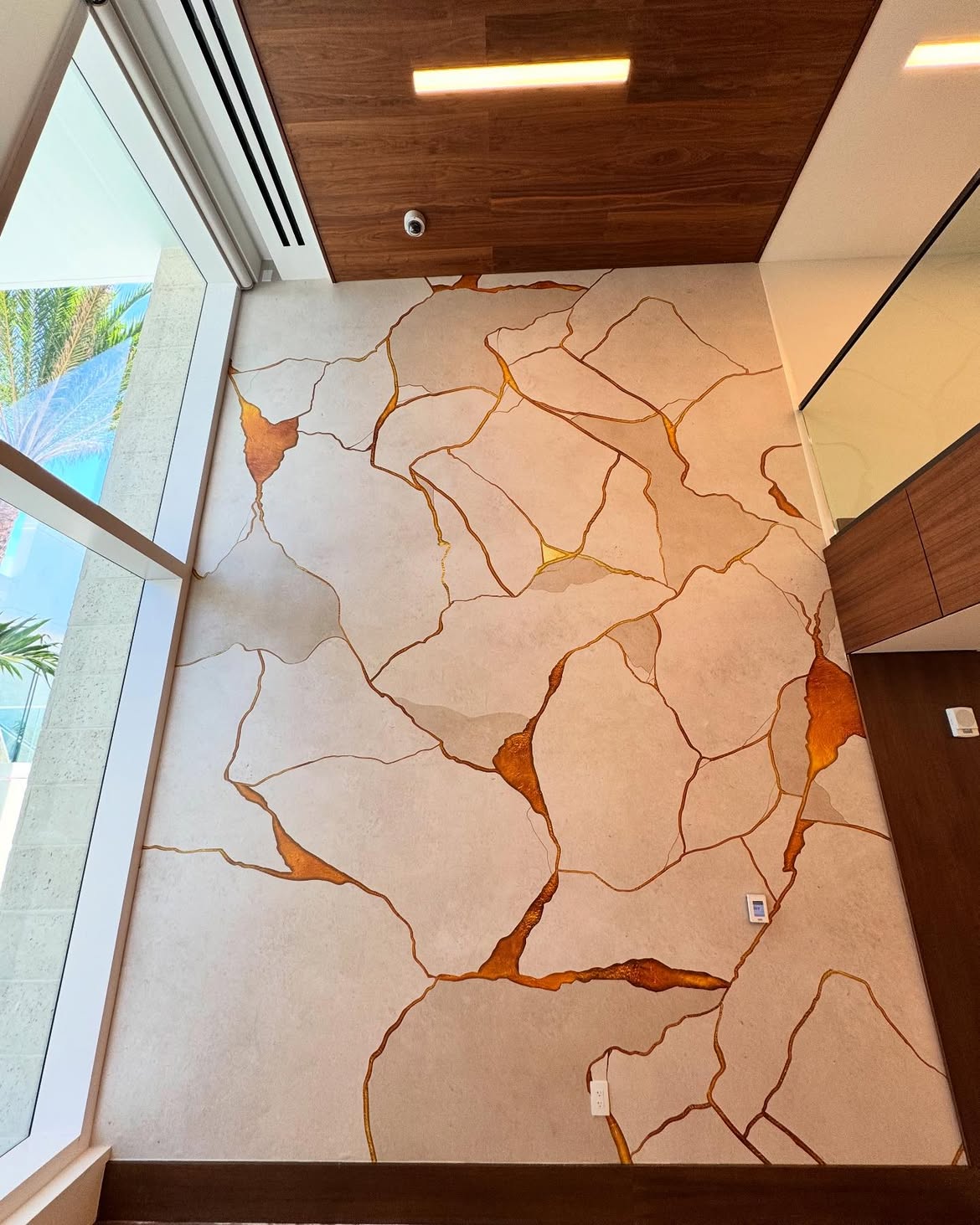 Custom kintsugi-inspired mural installed at Alina Residences
