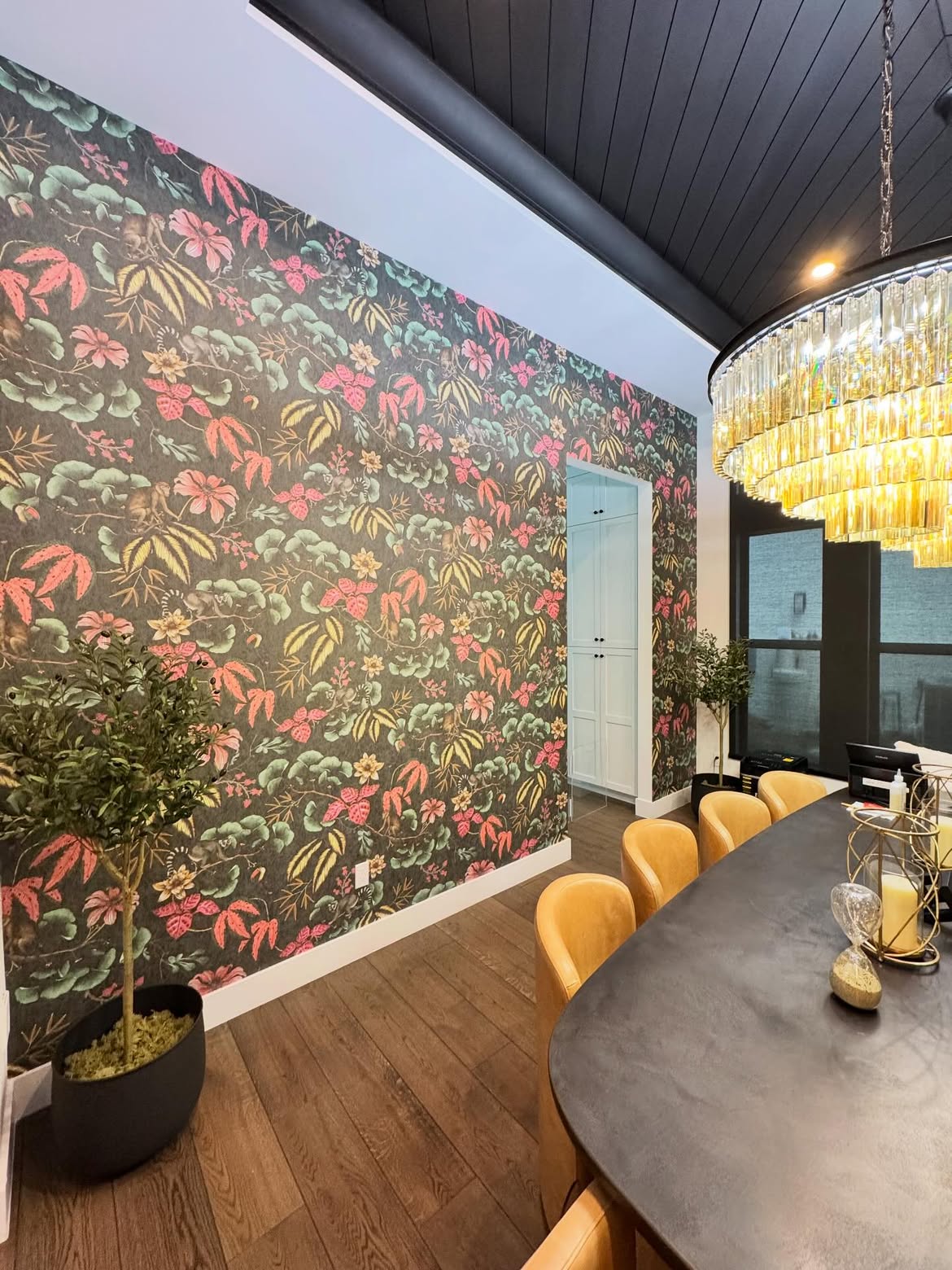 Luxury dining room with bold botanical wallpaper installation