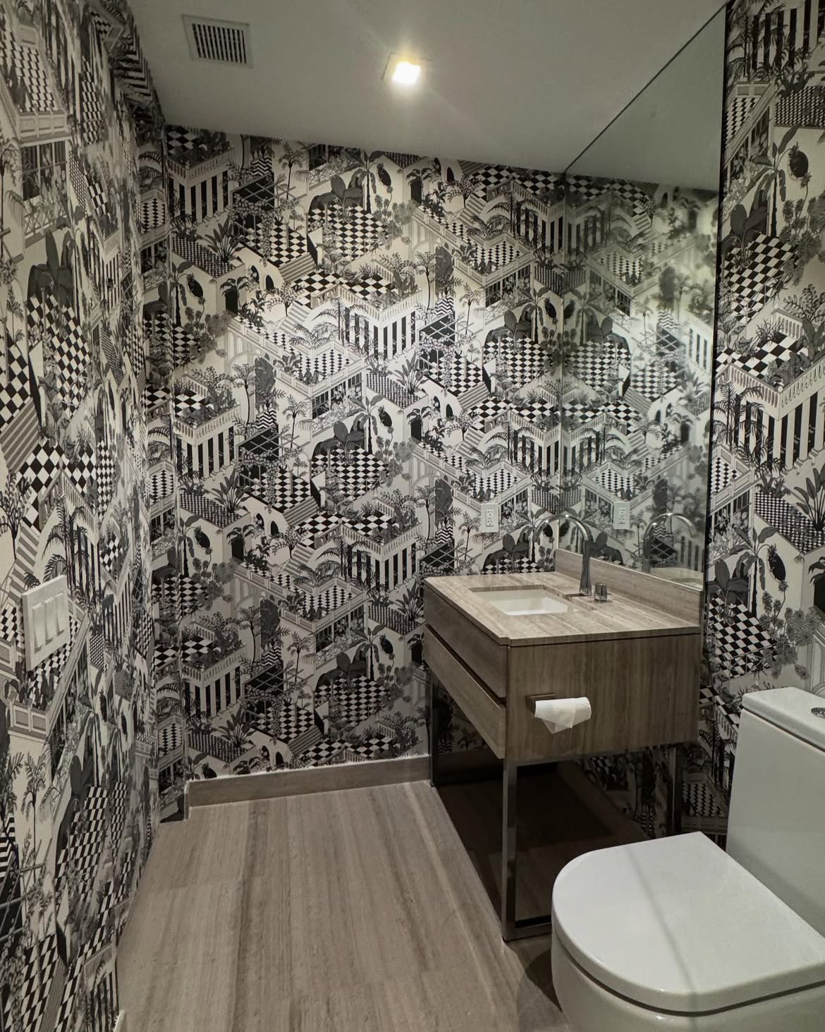 Black and white designer wallpaper installed in an Armani Residences powder room