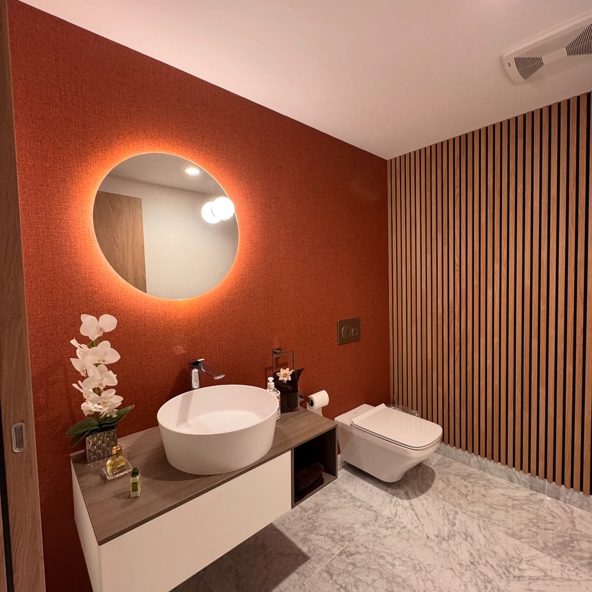 Contemporary powder room with terracotta wallcovering and wood details