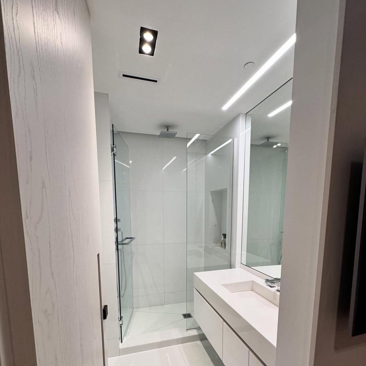 Bathroom ceiling after professional repair and white paint finish